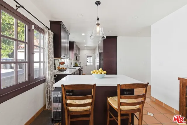 a view of a dining room with furniture large windows and wooden floor