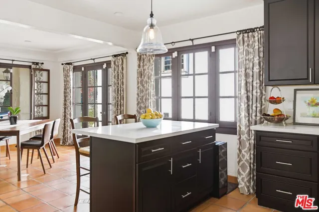 a kitchen with a table chairs sink and cabinets