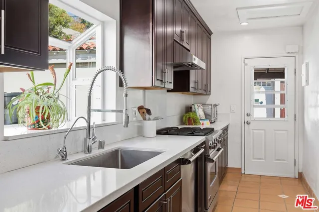 a kitchen that has a sink and a stove