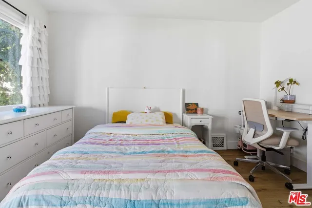 a bedroom with a bed a table and chair