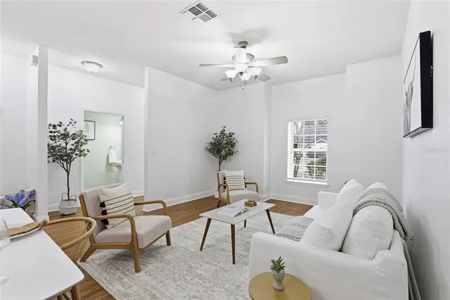 a living room with furniture and a chandelier