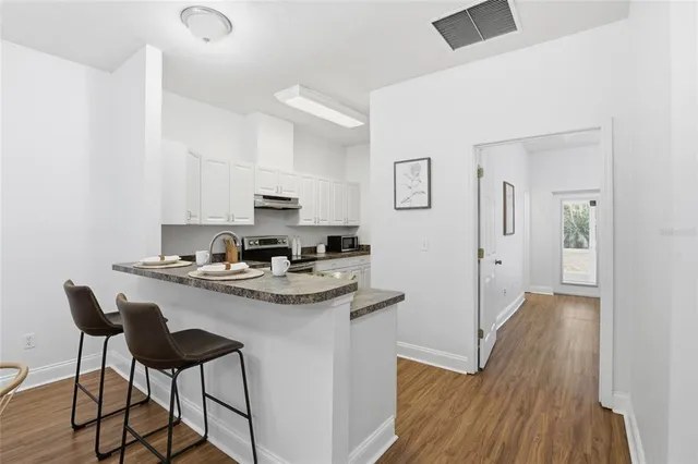 a kitchen with stainless steel appliances granite countertop a sink and a stove