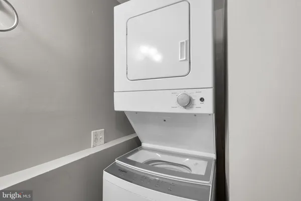 a utility room with a wooden floor and mirror
