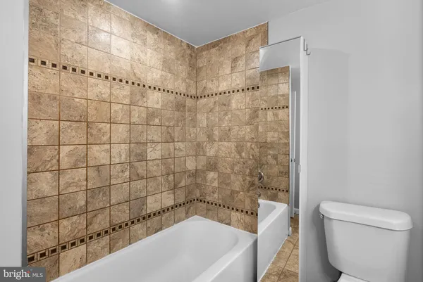a bathroom with a bathtub and shower