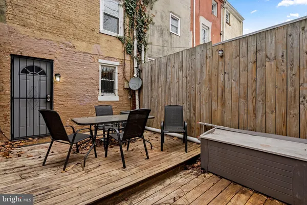 a balcony with table and chairs