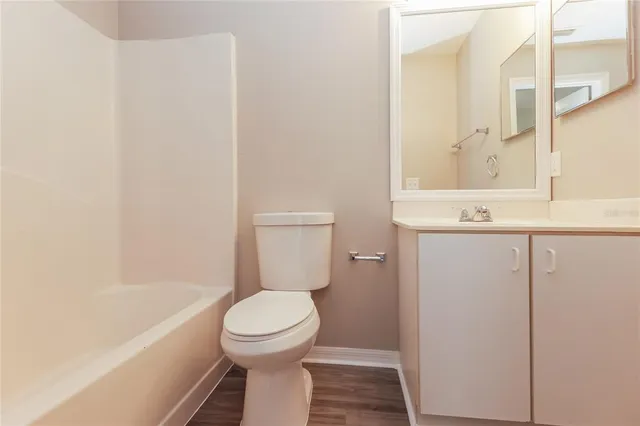 a bathroom with a toilet and a bathtub