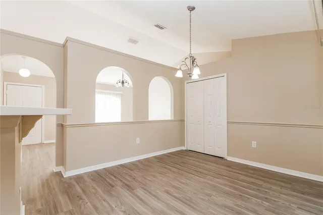 a view of a room with wooden floor and staircase