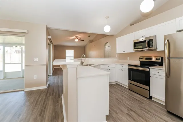a kitchen with stainless steel appliances a stove sink and refrigerator