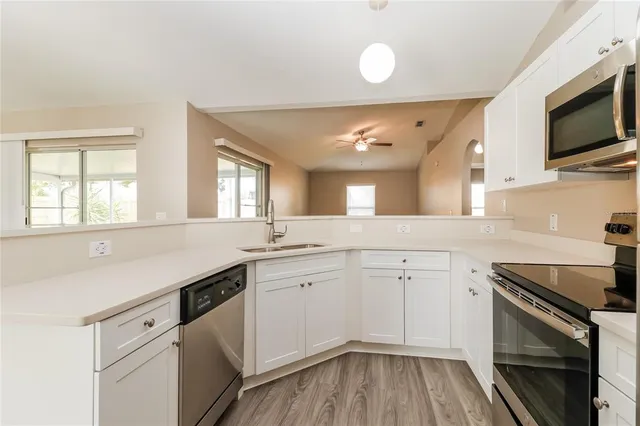 a kitchen with a sink stove and microwave