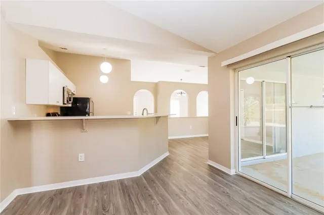 a view of kitchen with cabinets and wooden floor