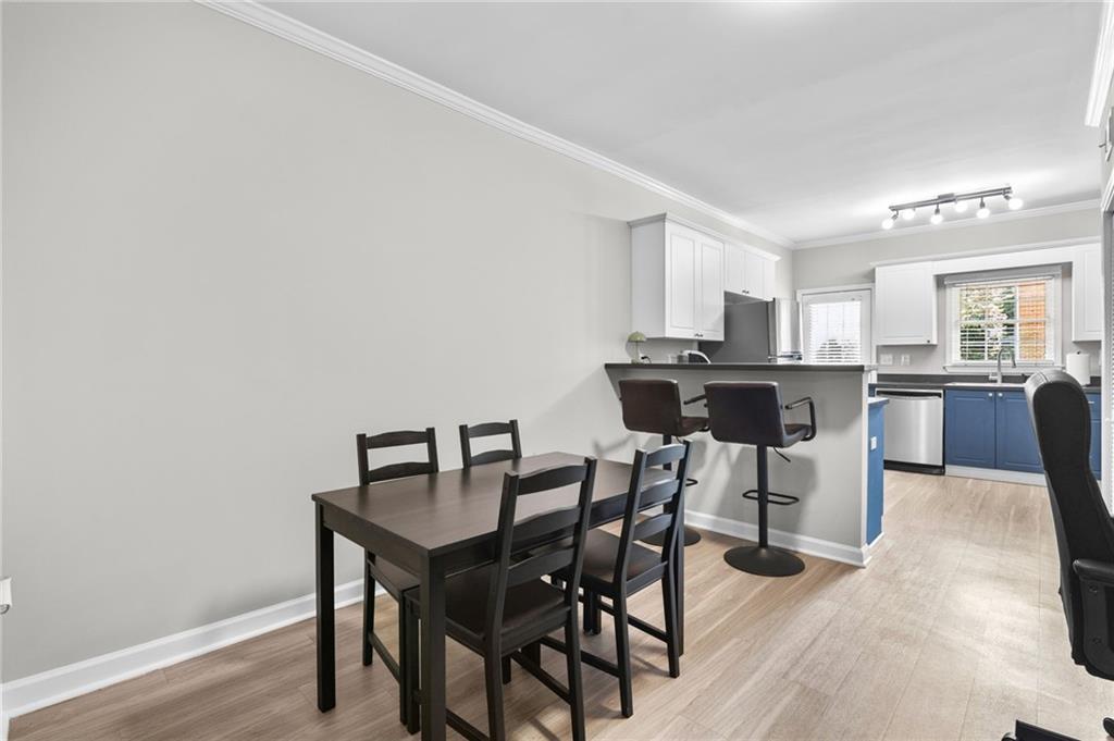 3675 Peachtree Road Northeast, Unit 45 Atlanta, GA 30319 - Photo 9 of 42 a view of a dining room with furniture and wooden floor