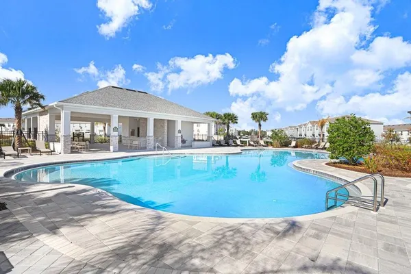 a view of a house with swimming pool and sitting area