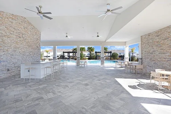 a living room with couches and kitchen view