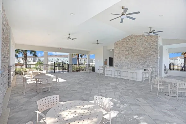 a living room with couches and kitchen view
