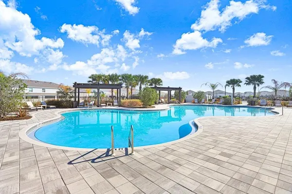 a view of a swimming pool with a lounge chairs
