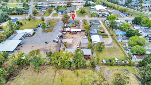 an aerial view of residential houses with outdoor space and swimming pool