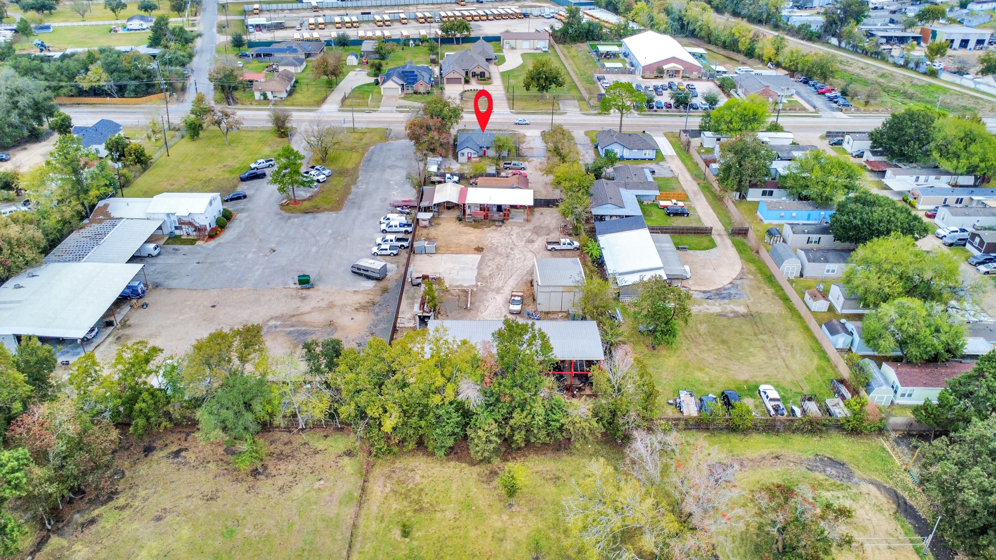 an aerial view of residential houses with outdoor space and swimming pool