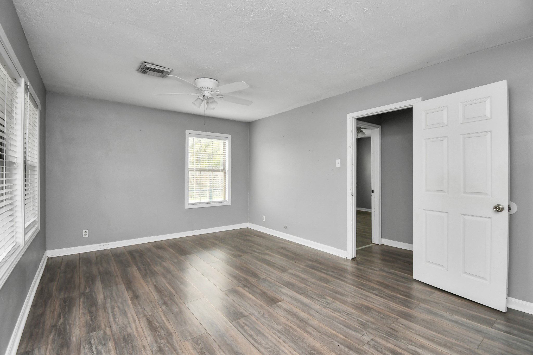 1008 Vista Road Pasadena, TX 77504 - Photo 19 of 50 a view of an empty room with wooden floor and a window