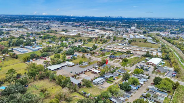 an aerial view of residential houses with outdoor space and swimming pool