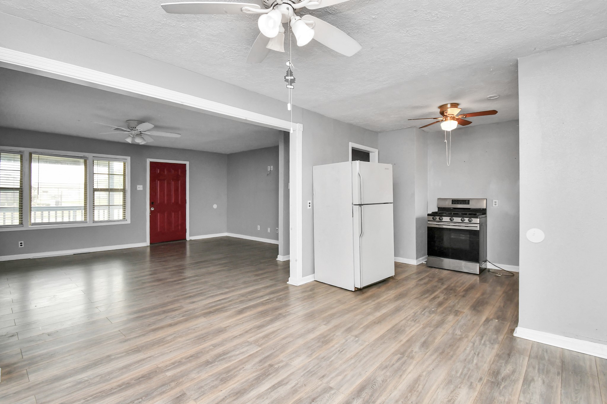 1008 Vista Road Pasadena, TX 77504 - Photo 10 of 50 a view of a kitchen with a refrigerator a ceiling fan and wooden floor
