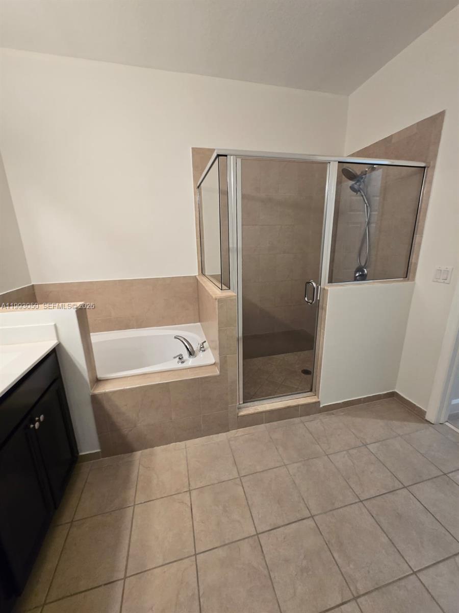 4268 Southwest 166th Court, Unit 4268 Miami, FL 33185 - Photo 12 of 21 a bathroom with a bathtub and a toilet