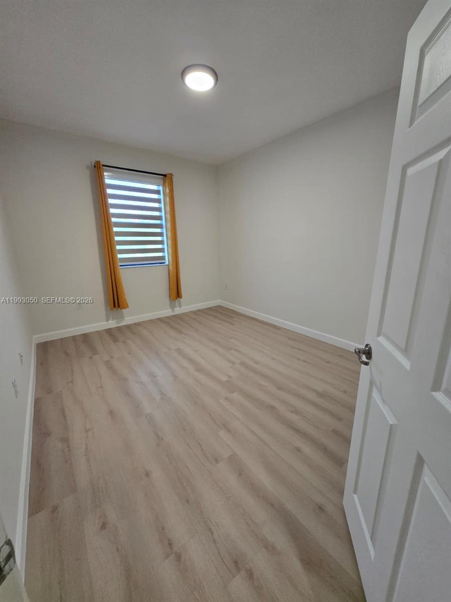 4268 Southwest 166th Court, Unit 4268 Miami, FL 33185 - Photo 14 of 21 a view of an empty room with a window