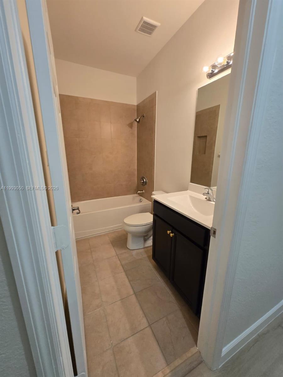 4268 Southwest 166th Court, Unit 4268 Miami, FL 33185 - Photo 17 of 21 a spacious bathroom with a double vanity sink toilet and shower