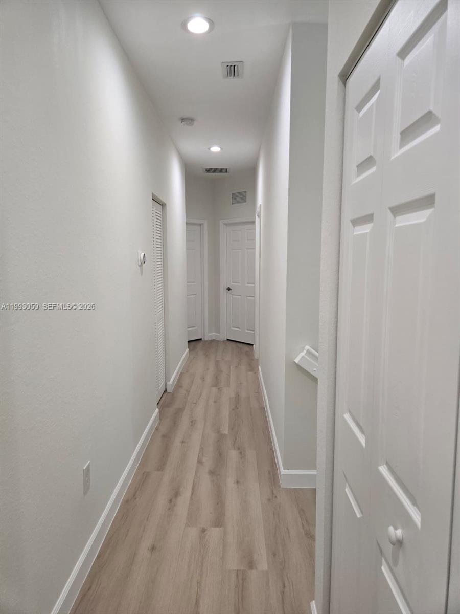 4268 Southwest 166th Court, Unit 4268 Miami, FL 33185 - Photo 9 of 21 a view of a hallway with wooden floor