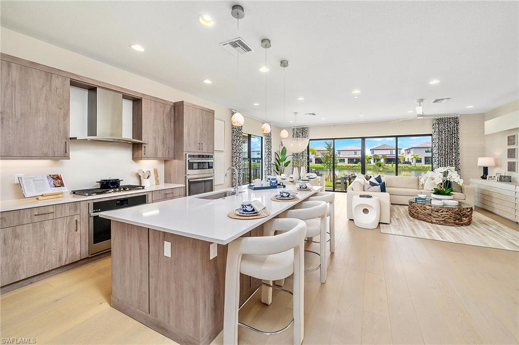 a kitchen with counter top space a sink cabinets and appliances