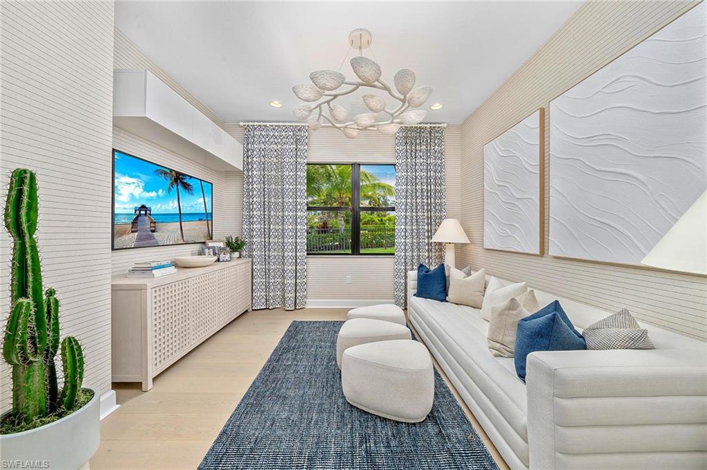 12777 Springbrook Court Estero, FL 33928 - Photo 11 of 27 a large room with a couch a large window and a rug