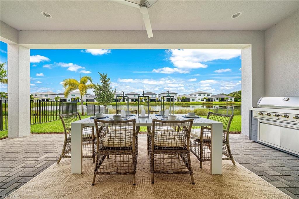 12777 Springbrook Court Estero, FL 33928 - Photo 13 of 27 a dining room with furniture and garden view