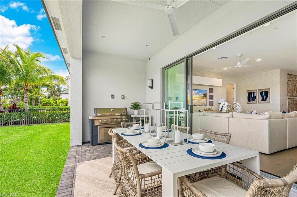 12777 Springbrook Court Estero, FL 33928 - Photo 14 of 27 a view of a dining room with furniture and a garden