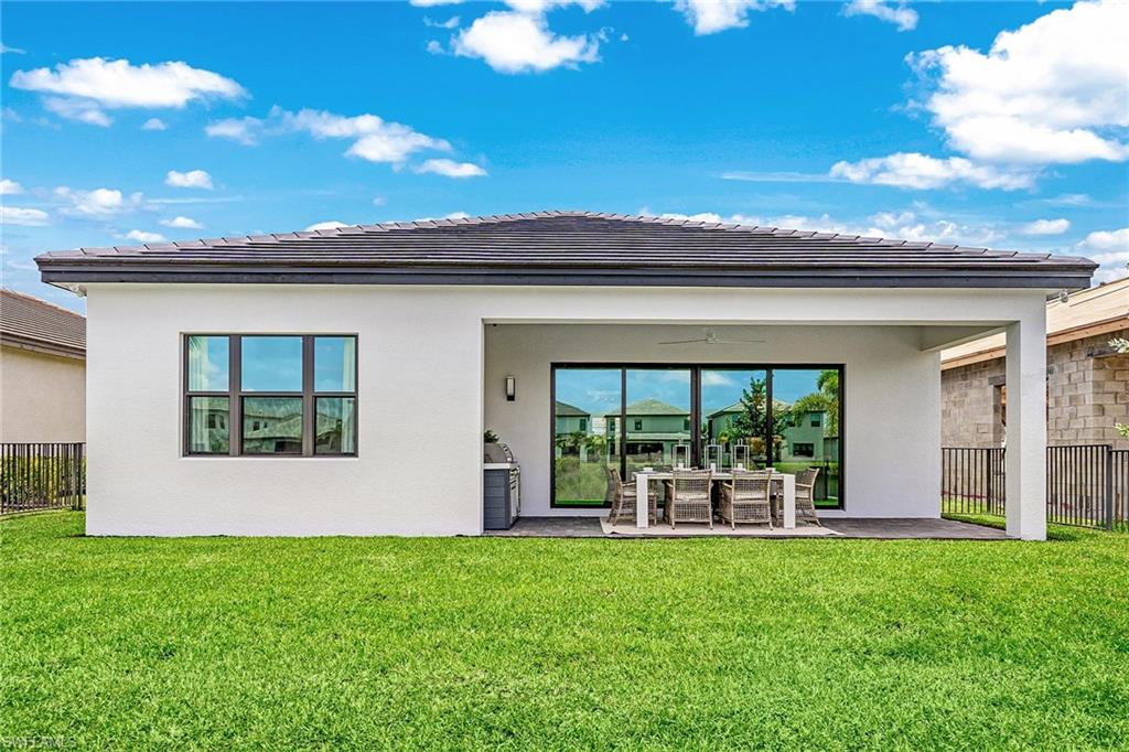 12777 Springbrook Court Estero, FL 33928 - Photo 15 of 27 a view of a house with backyard and porch