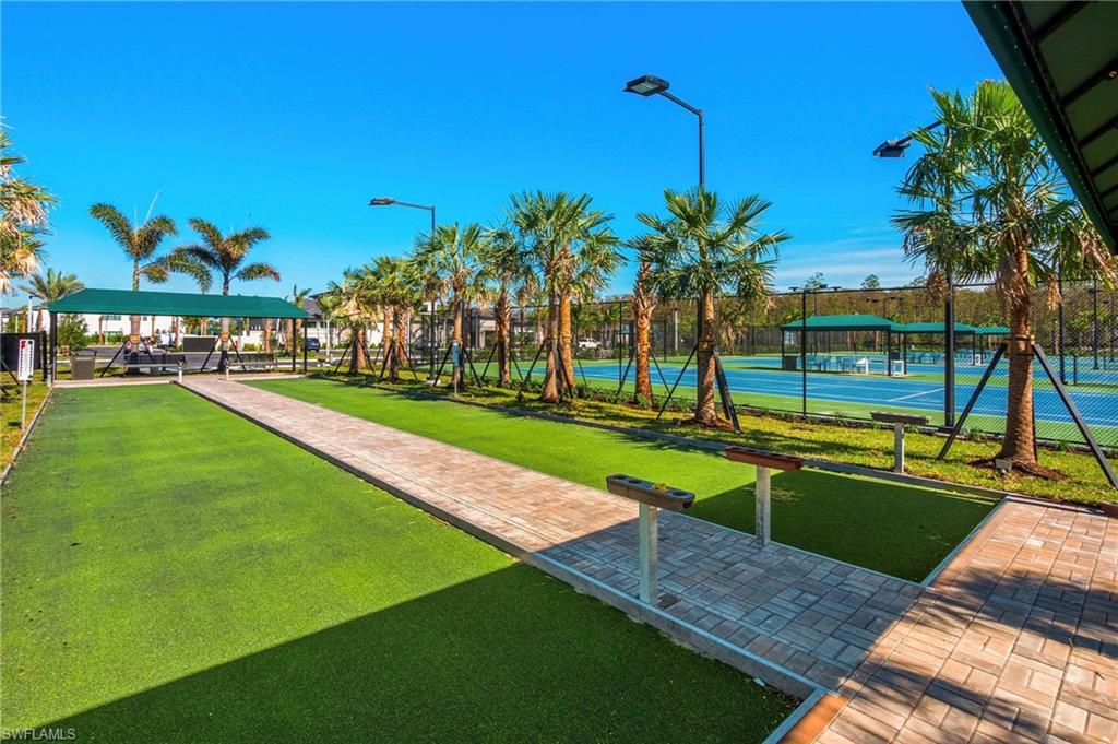 12777 Springbrook Court Estero, FL 33928 - Photo 20 of 27 a view of a swimming pool with a yard and palm trees