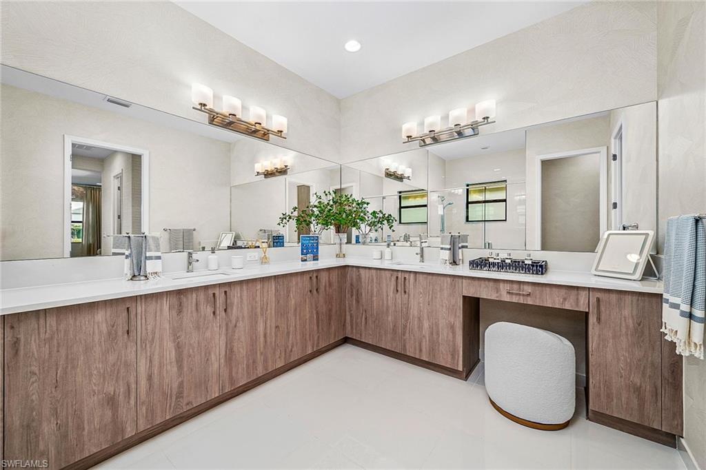 12777 Springbrook Court Estero, FL 33928 - Photo 9 of 27 a bathroom with a sink double vanity and a mirror