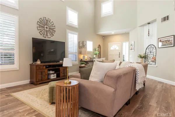 a living room with furniture and wooden floor
