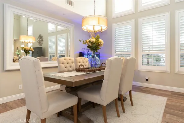 a view of a dining room with furniture and chandelier