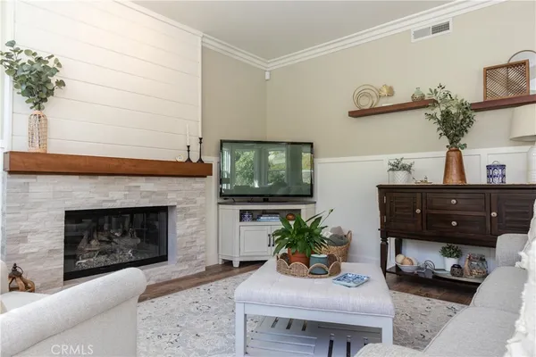 a living room with furniture and a fireplace