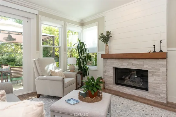 a living room with furniture a flat screen tv and a large window