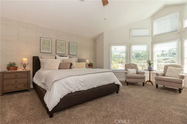 a spacious bedroom with a bed and a couch