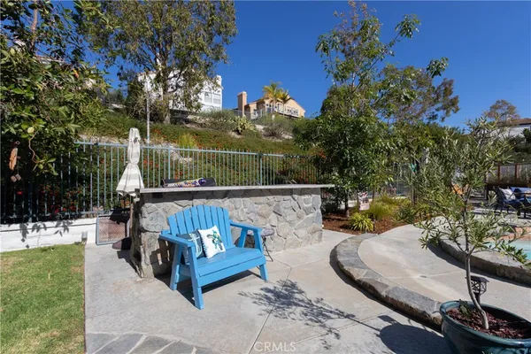 a view of a patio with a table chairs and a yard