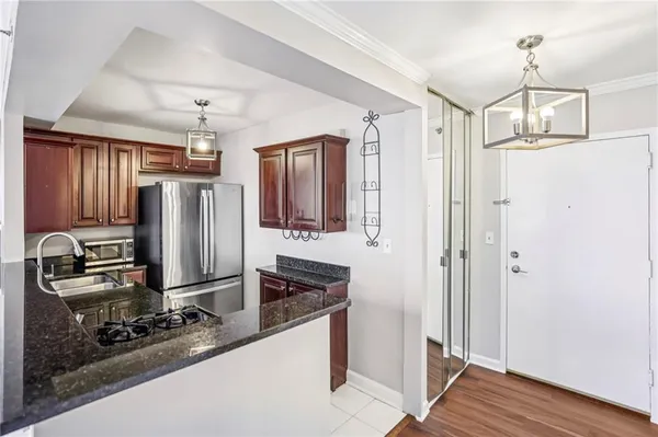 a kitchen with stainless steel appliances granite countertop a refrigerator and a stove