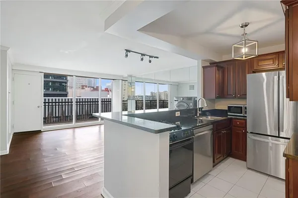 a kitchen with stainless steel appliances granite countertop a sink stove and refrigerator