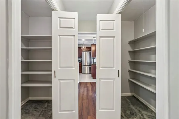 a view of walk in closet with empty racks