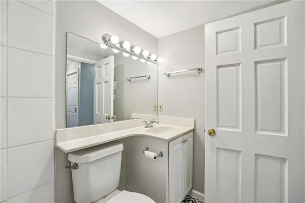 a bathroom with a sink a toilet and a mirror