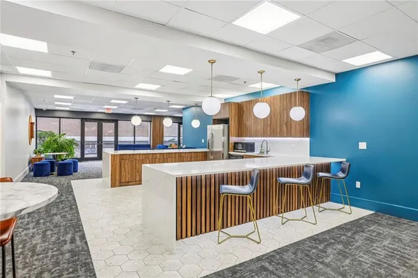 a large kitchen with a table and chairs
