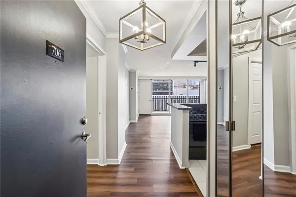 a view of a hallway with wooden floor and staircase