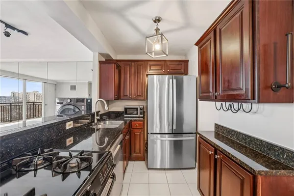 a kitchen with stainless steel appliances a sink stove and refrigerator