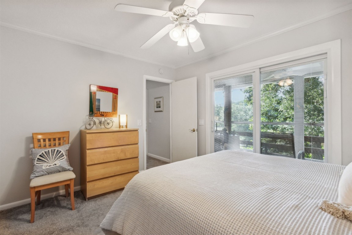 2328 Sadler Road, Unit 8F Fernandina Beach, FL 32034 - Photo 11 of 32 a bedroom with a bed and a chandelier