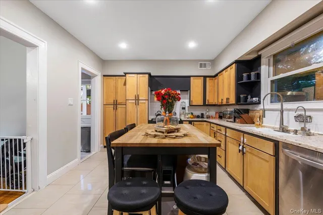 a kitchen with a table chairs sink and cabinets